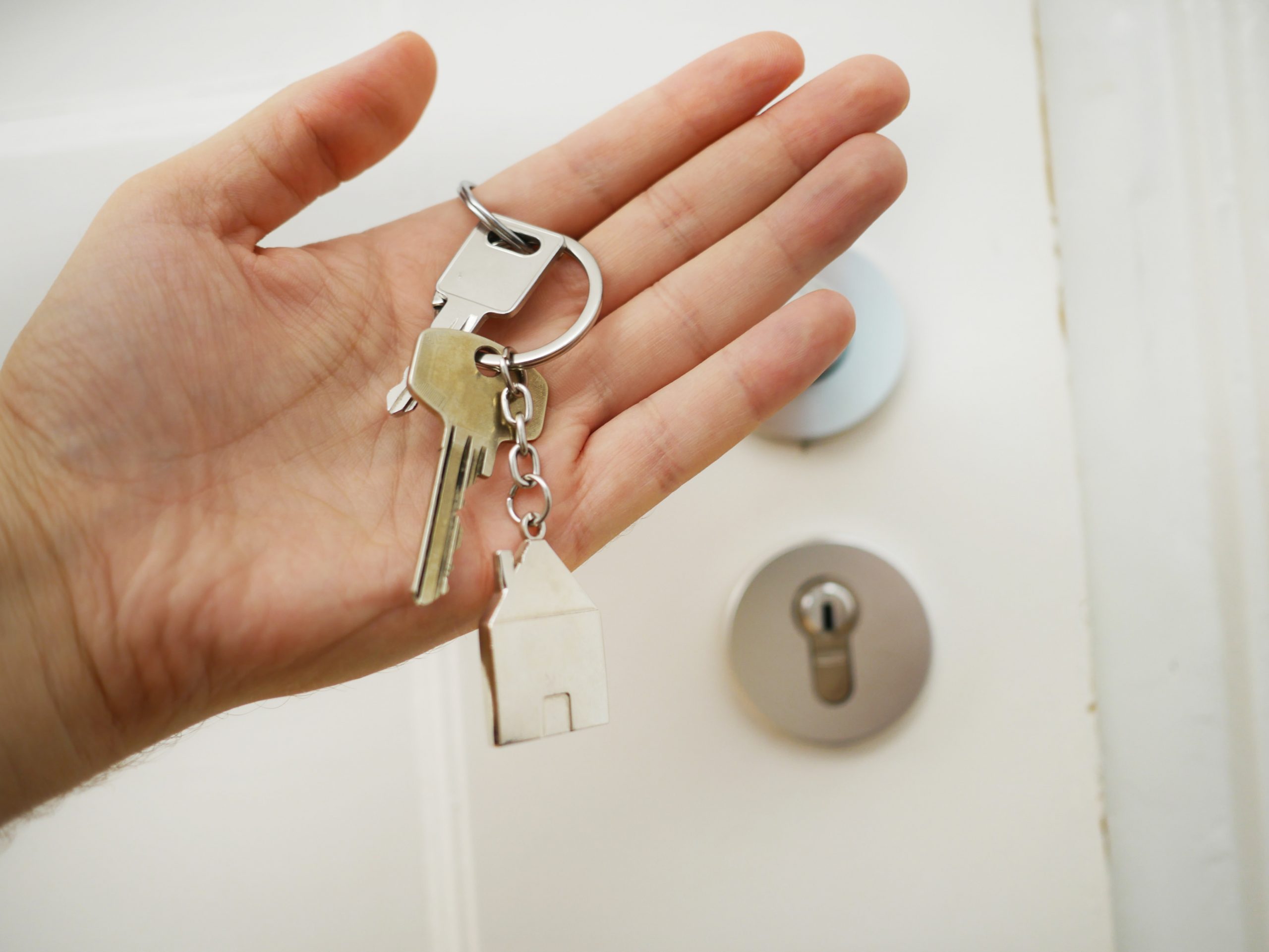 Hand holding house keys